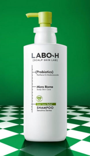 LABOR-H shampoo bottle on a green and white checkered background
